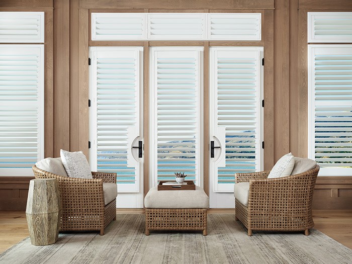 Beautiful stylish shutters with brown woven seating and shite cushions. 